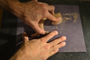 Sanding the flats. Take care that the sandpaper does not raise up and dub the edges.