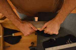 Removing the bow from the spine by bending it. I support the blade at the center of the bow (concave side up), then push down on either side until the bow is removed.