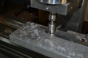 Using a fly cutter to true the milling bed surface.