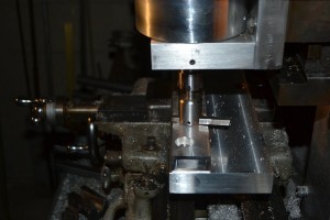 Fly cutting the spine slotting fixture base.  This ensures that the spine is held parallel to the table so that the slot in the spine is, in turn, parallel to the sides of the spine.